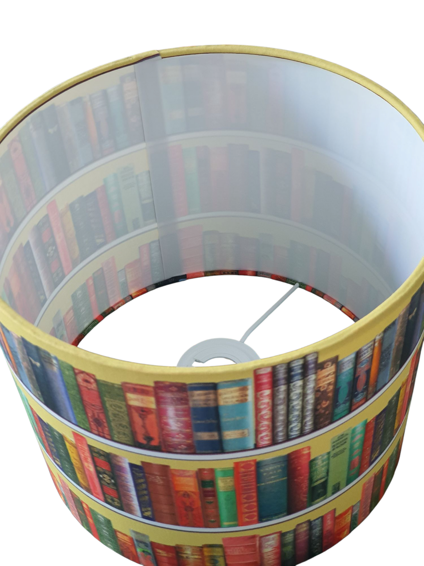 A view of the inside of the handmade lampshade showing the fire retardant white PVC and the hand rolling of the fabric over the rings.