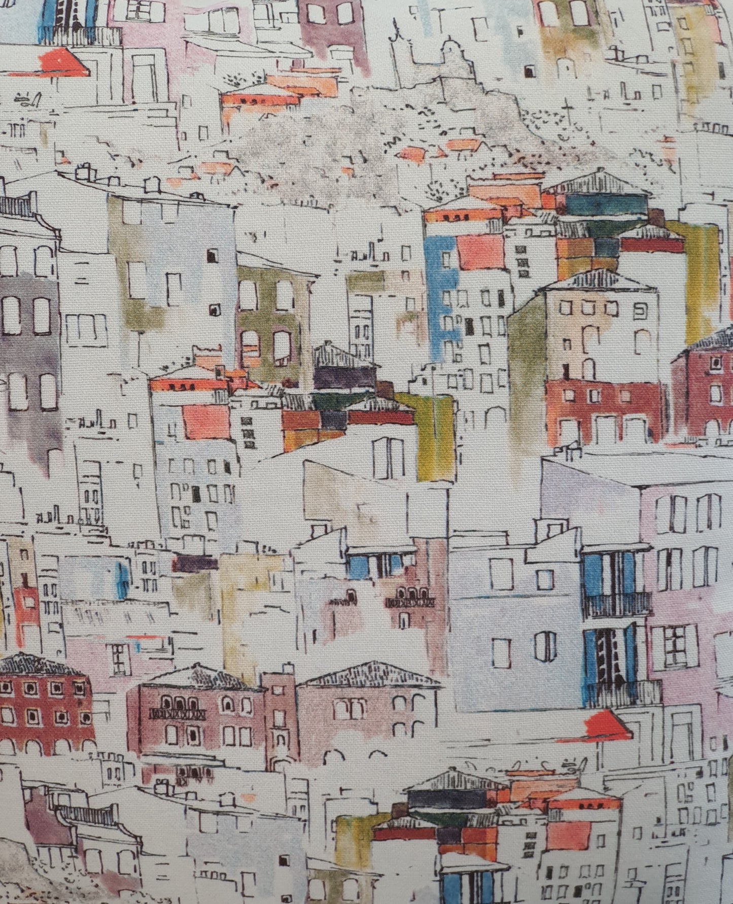 Colourful watercolour style Italian style houses on a light background fabric. This photo is a close up of the multicolour watercolour style houses, which it is said is based on houses in Florence.