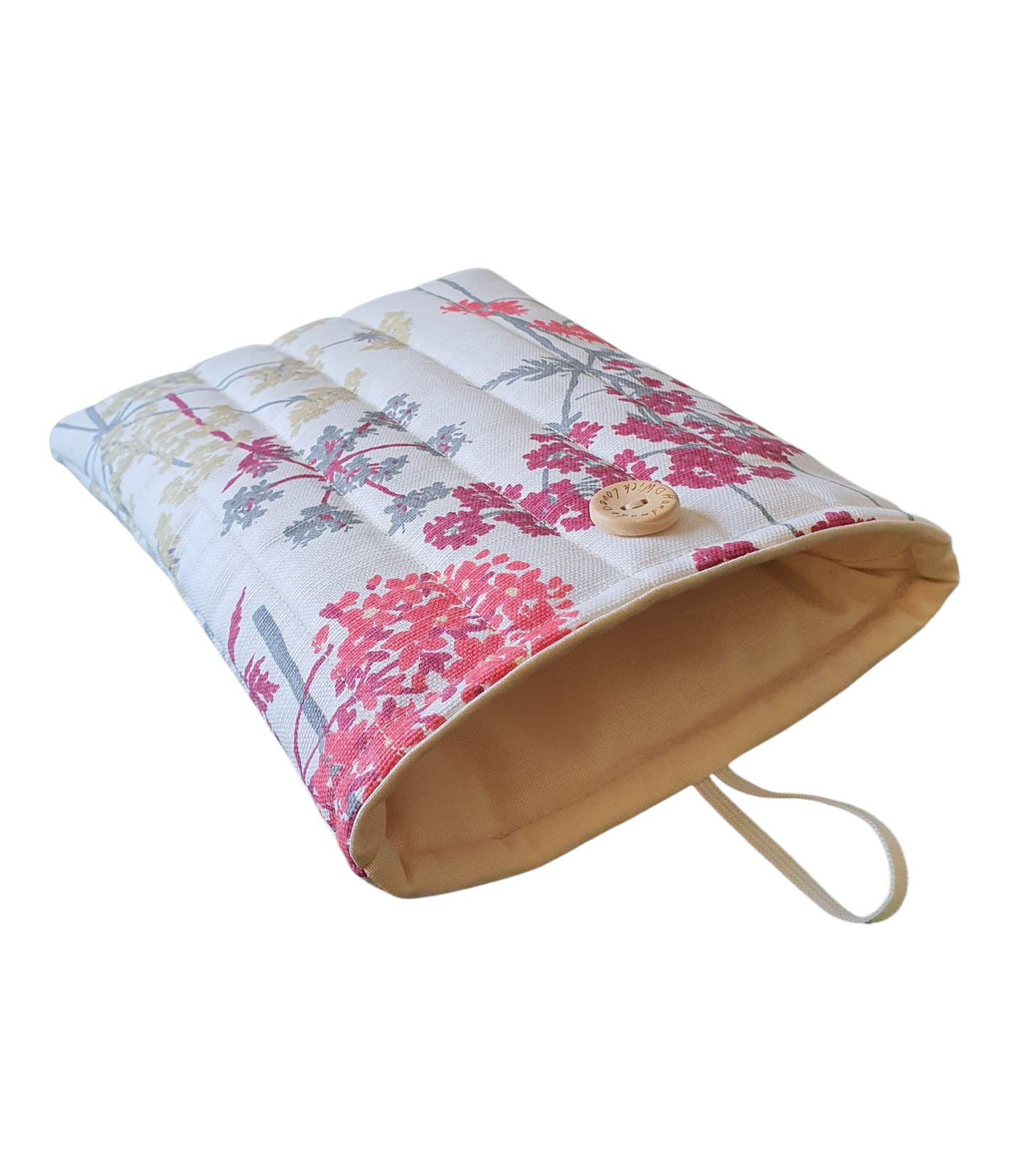 The Book Pouch is lined with neutral fabric and fastens with elastic and a button as shown in the photo.