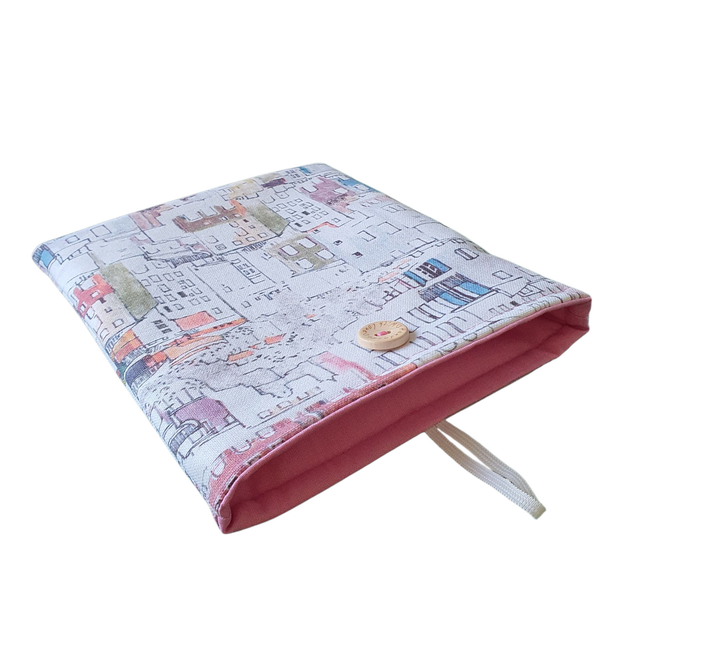 The handmade Book Cover is padded with fusible wadding and lined with complementing pink fabric and fastens with elastic and a button.