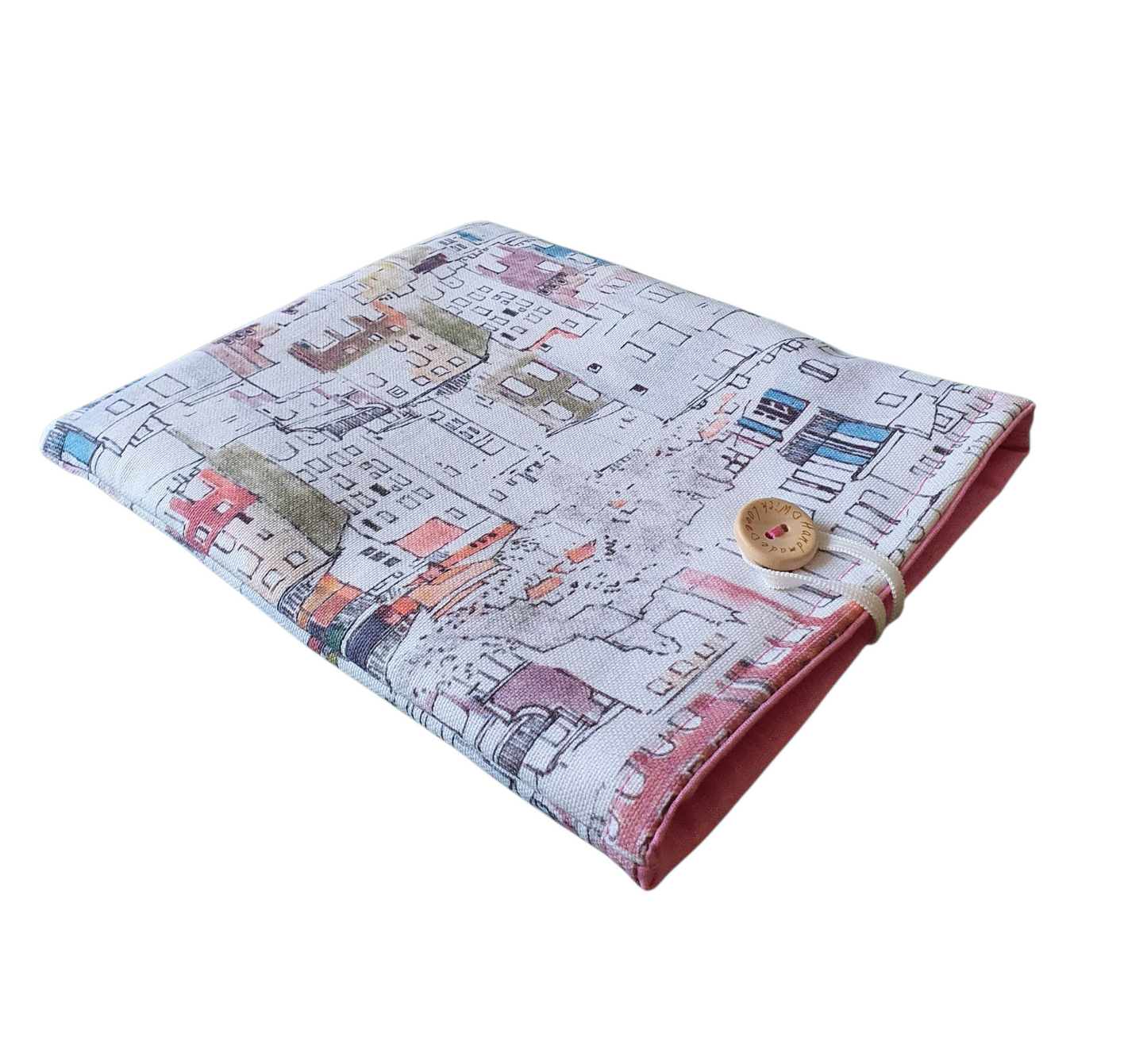 The handmade Book Pouch fastens with elastic and a button.