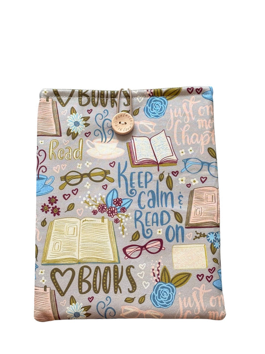 Handmade Padded Book Pouch made with book themed fabric, being an ideal Book Lovers Gift.  The Book Cover is approximately 24cms x 18.5cms and as well as offering protection for books may also be suitable for a Kindle e-Reader but please check the measurement of your device prior to placing an order.