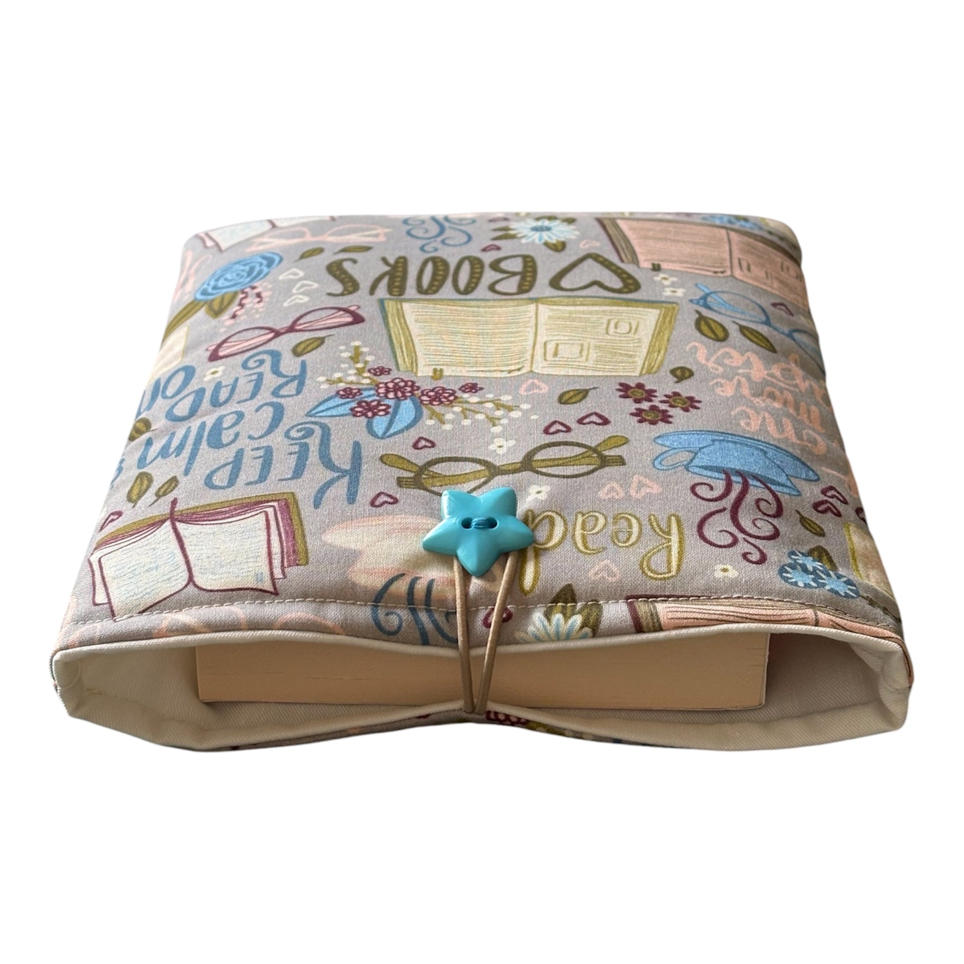 The reading books themed fabric Book Pouch is approximately 23cms x 18cms and has elastic and button fastening.  Please note the book in the photograph is not included and is for illustrative purposes only.
