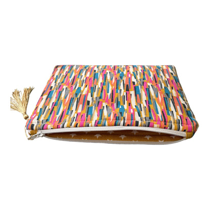 Part of the lining fabric can be seen in this photo and the yellow and white star fabric complements the multicolour needlecord outer fabric.  The cosmetics purse fastens with a white zip. 