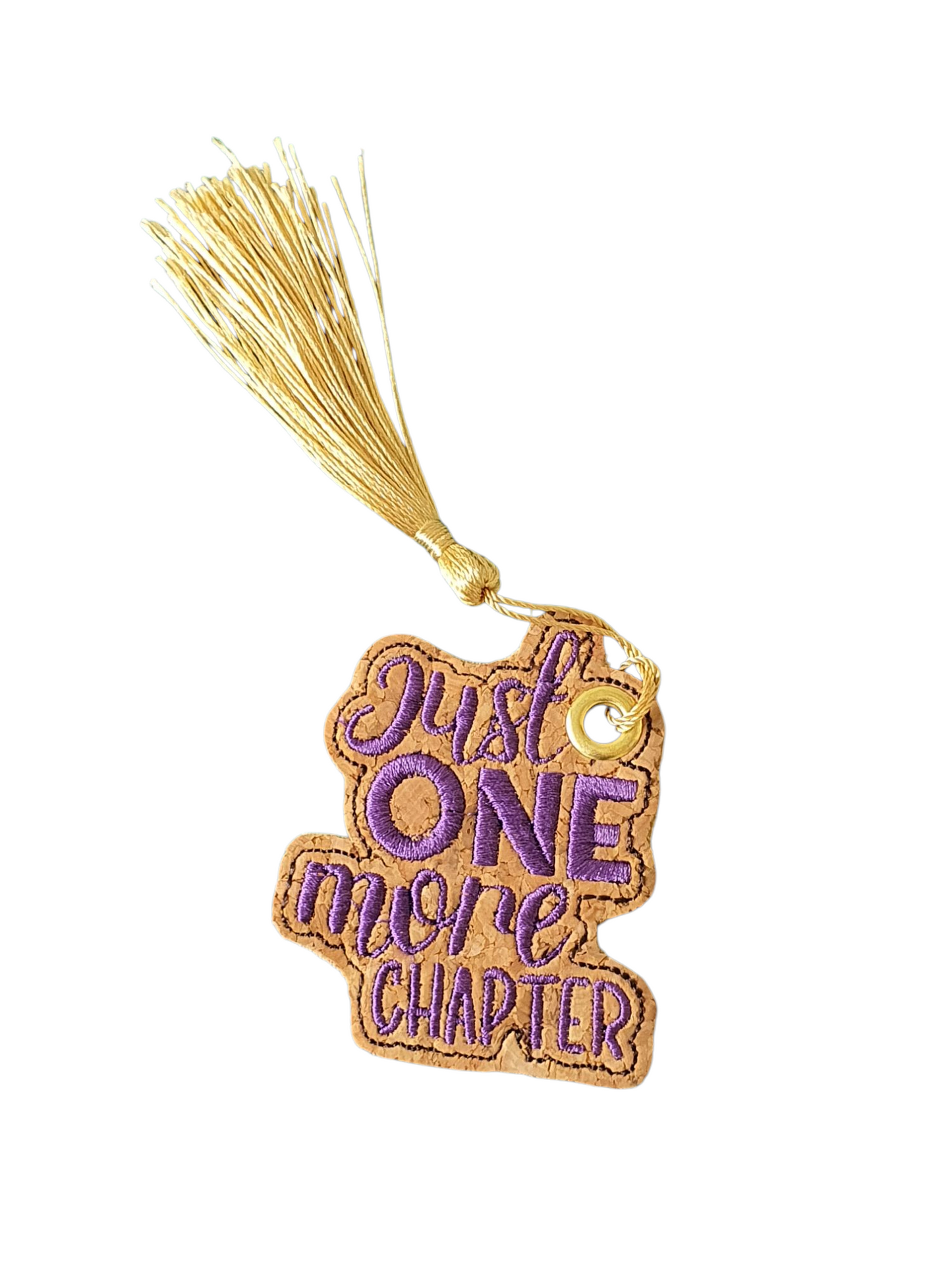 Purple embroidered 'Just One More Chapter' bookmark.  The Bookmark has been finished with an eyelet and gold coloured tassel.