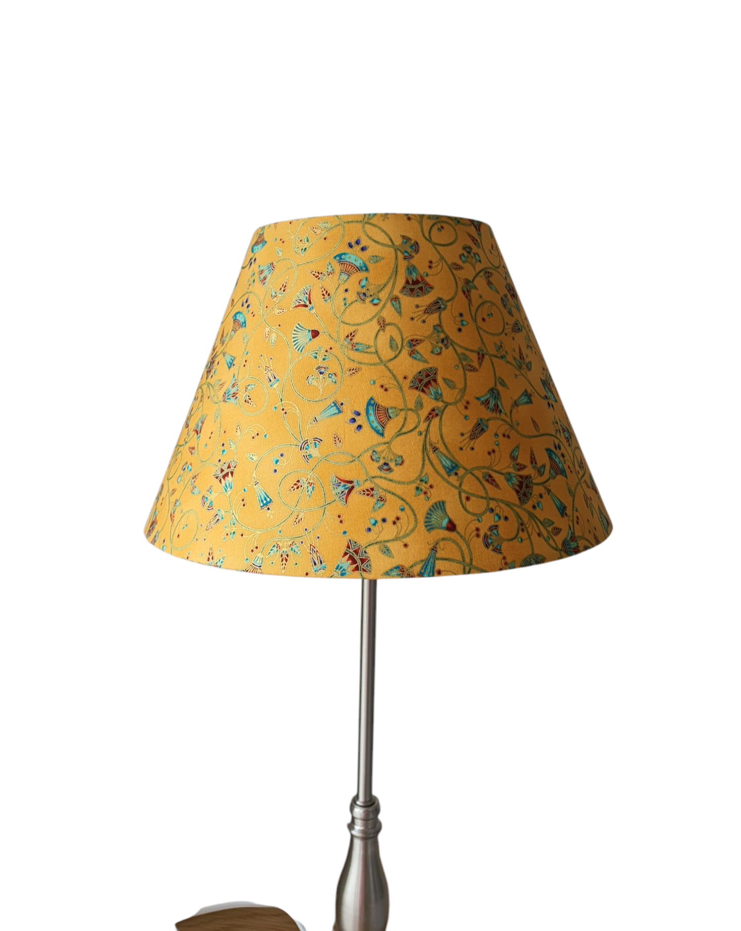 The handmade shade shown on a lamp base, which is not included.  The pattern of the fabric is called Palatial Gardens and is in honey gold.
