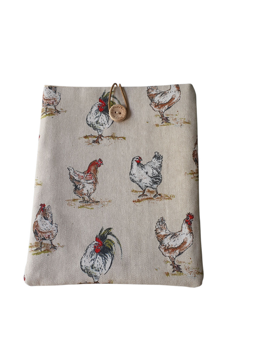 Handmade padded Book Pouch made with Chicken Hens patterned fabric, lined with neutral fabric, padded with fusible wadding and elastic and button closure.  The padded Book Cover is approximately 20cms x 17cms (8inches x 7inches) and will protect books from wear and tear whilst being carried on the go.