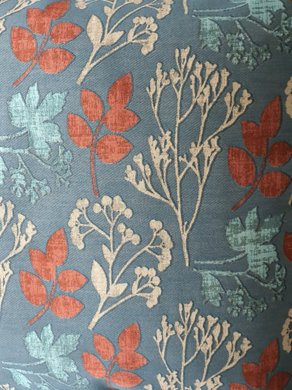 Close up of the Elliott Teal Peacock fabric by Prestigious Textiles which has been used to make the front of the cushion cover.