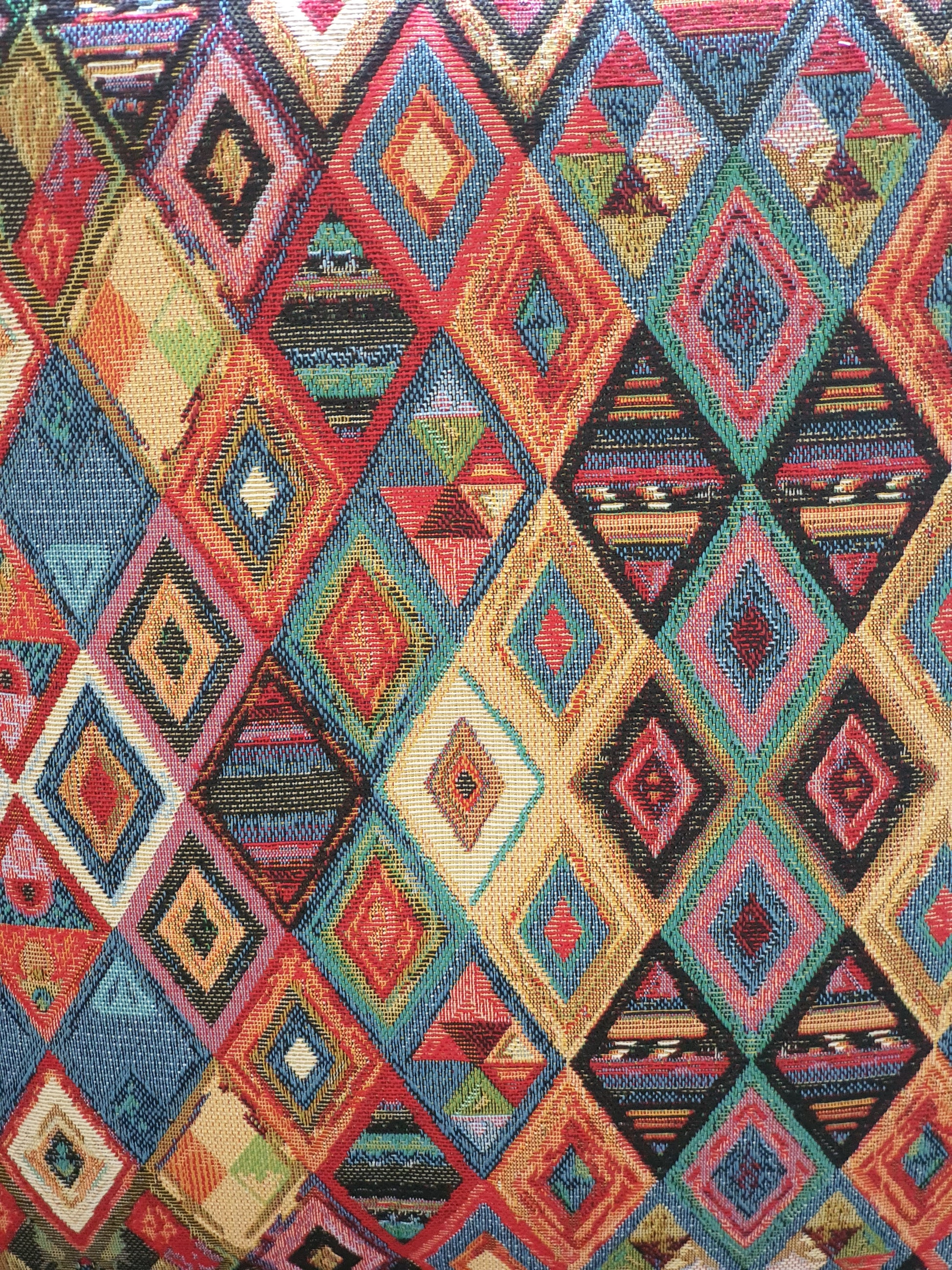 Close up of the colourful multicolour pattern of the tapestry fabric.