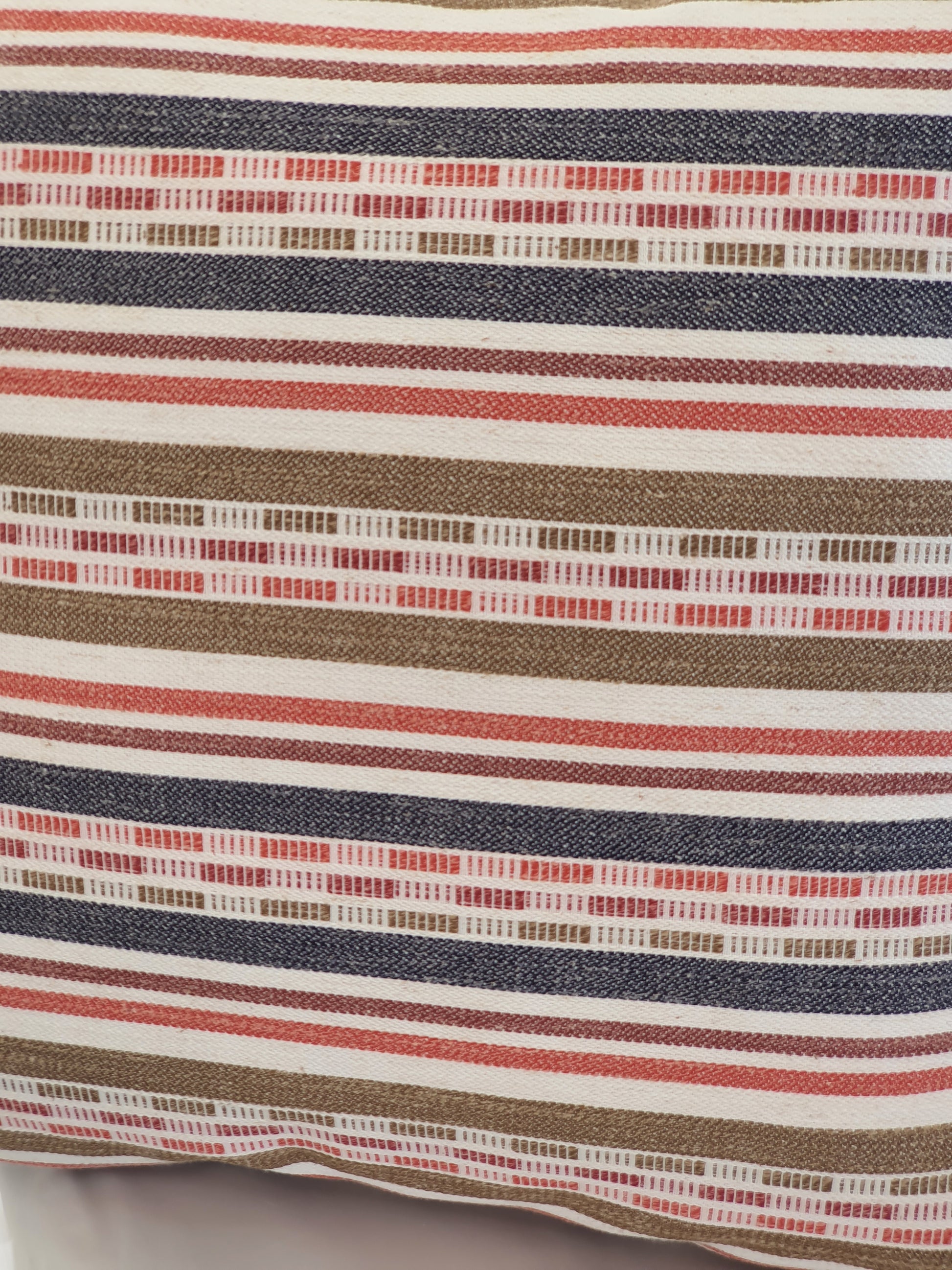 A close up of the multicolour striped fabric used to make the zipped cushion cover.