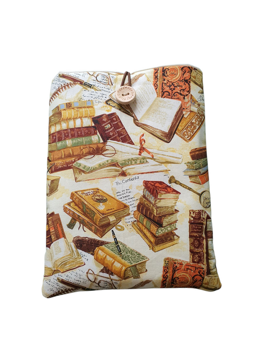 Handmade padded Book Cover made with library book themed fabric, lined with complementing neutral fabric, elastic and button fastening.  Ideal Book Lovers Gift to protect books from wear and tear and would also be suitable for the smaller Kinder or e-Reader.