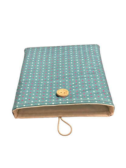 The handmade padded Book Cover is lined with neutral fabric, padded with fusible wadding and has elastic and button fastening.