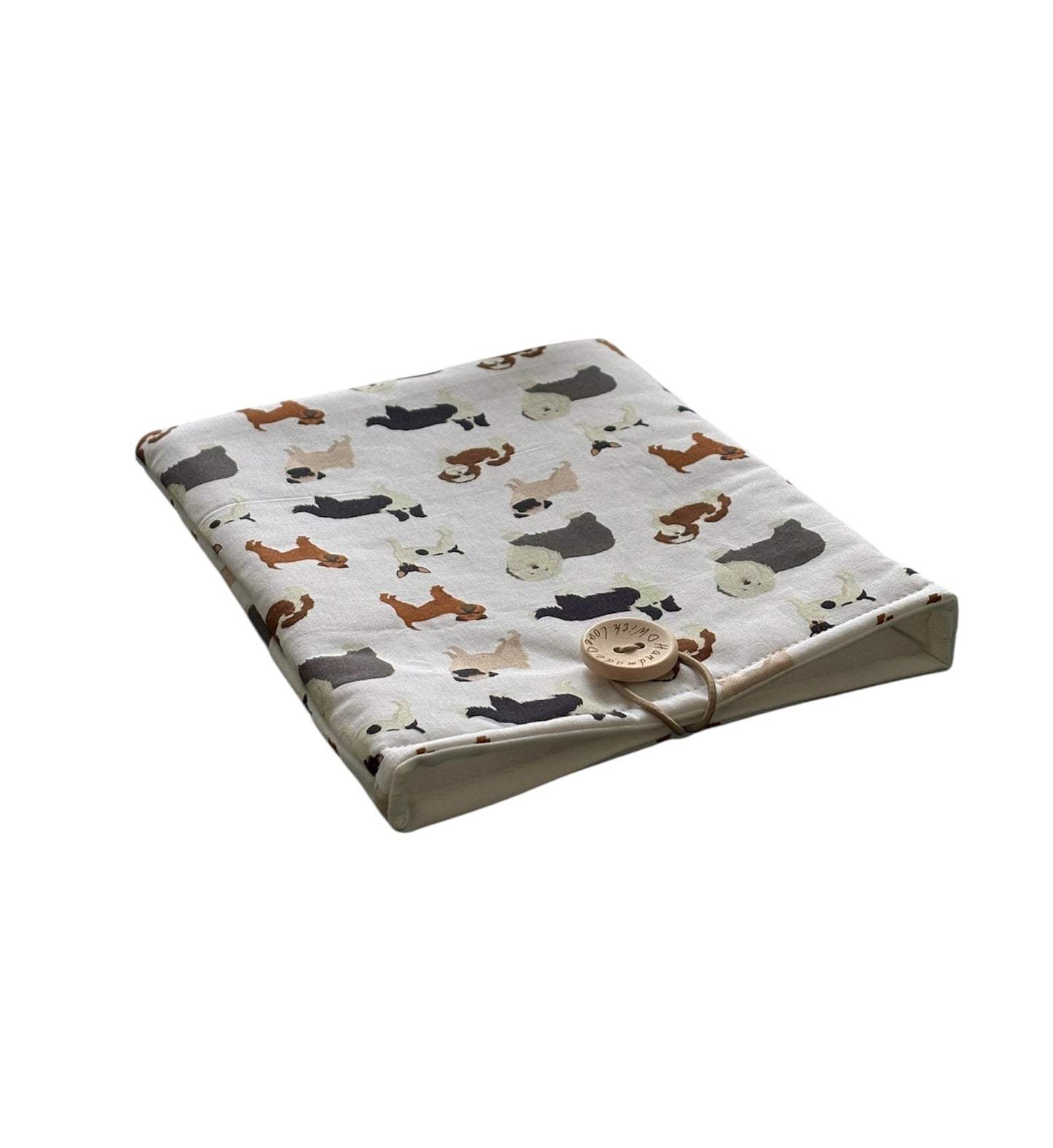As shown in the photo, the padded Book Pouch is lined with neutral fabric and has elastic and button fastening.