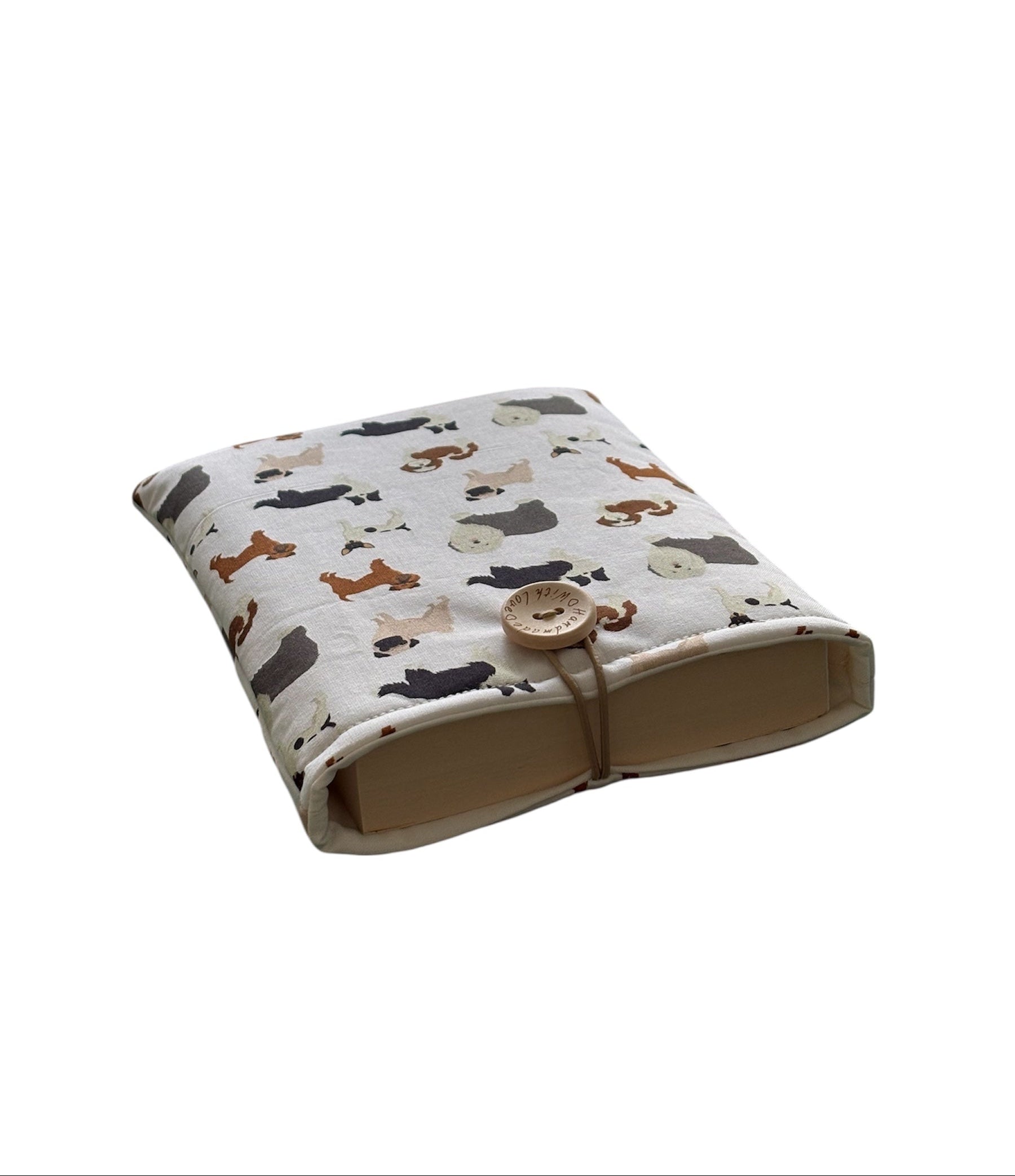 The padded Book Cover is approximately 15.5cms x 21cms, is padded with fusible wadding, lined with neutral fabric and has elastic and button fastening.  Please note the book in the photo is not included and is for illustrative purposes only.