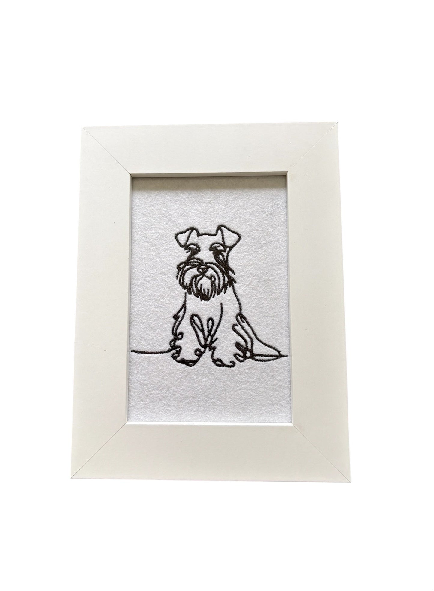 Machine embroidered black sketch style Miniature Schnauzer.  The embroidered pattern is on white felt, backed with stabiliser, and mounted in a white wooden frame.  The display area is 4" x 6" (10cms x 15cms) and the total frame size is 6" x 8" (15cms x 20cms).  This would be an ideal Dog Lovers Gift idea.
