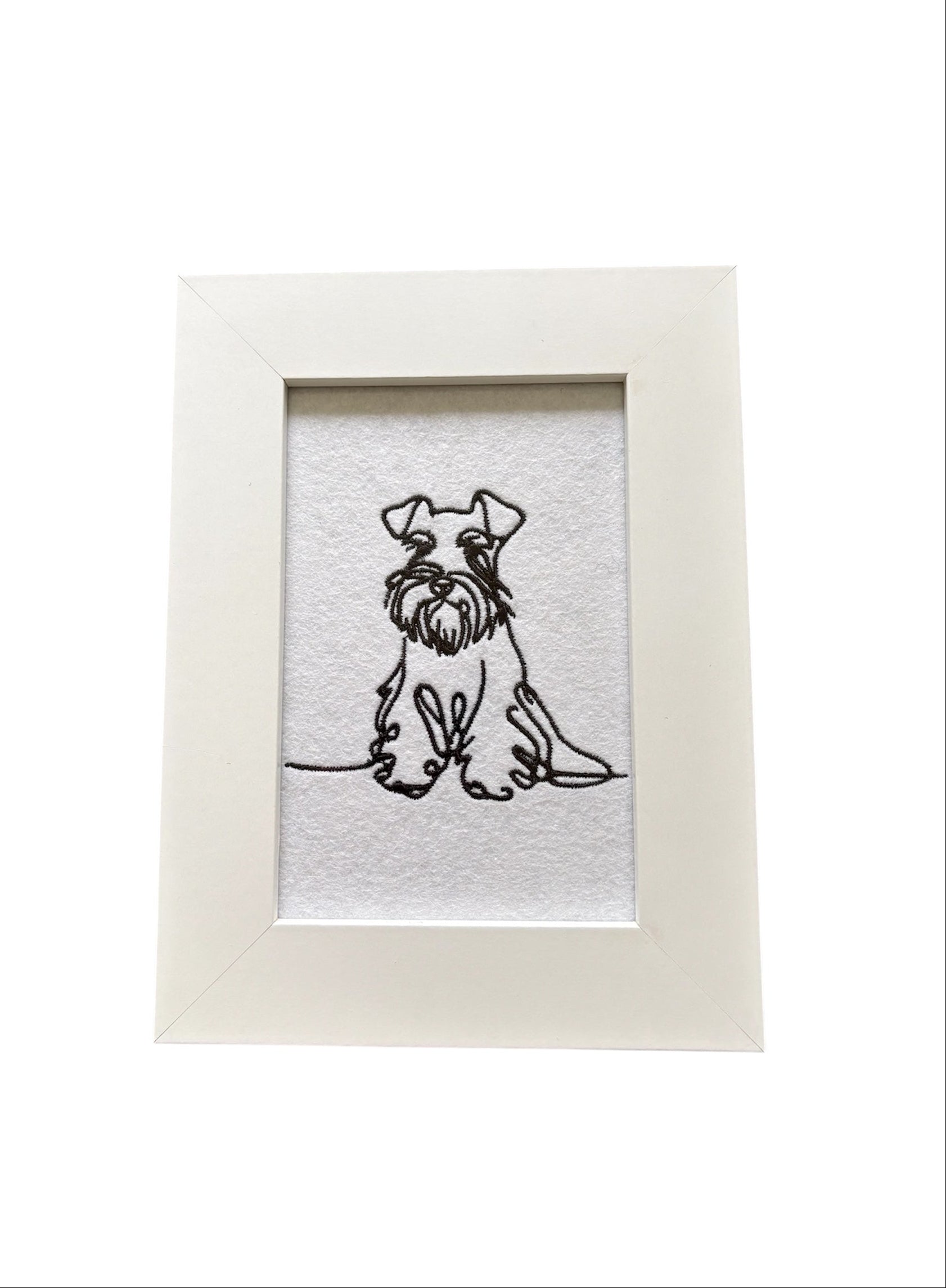 Machine embroidered black sketch style Miniature Schnauzer.  The embroidered pattern is on white felt, backed with stabiliser, and mounted in a white wooden frame.  The display area is 4" x 6" (10cms x 15cms) and the total frame size is 6" x 8" (15cms x 20cms).  This would be an ideal Dog Lovers Gift idea.