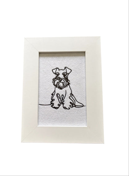 Machine embroidered black sketch style Miniature Schnauzer.  The embroidered pattern is on white felt, backed with stabiliser, and mounted in a white wooden frame.  The display area is 4" x 6" (10cms x 15cms) and the total frame size is 6" x 8" (15cms x 20cms).  This would be an ideal Dog Lovers Gift idea.