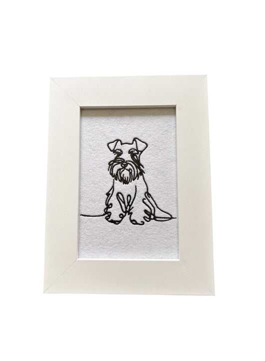 Machine embroidered black sketch style Miniature Schnauzer.  The embroidered pattern is on white felt, backed with stabiliser, and mounted in a white wooden frame.  The display area is 4" x 6" (10cms x 15cms) and the total frame size is 6" x 8" (15cms x 20cms).  This would be an ideal Dog Lovers Gift idea.