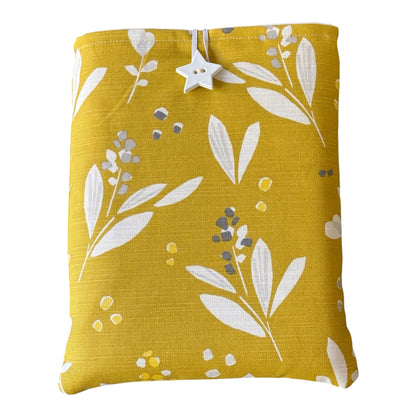 The handmade Book Pouch is padded with polyester wadding, lined with neutral cotton fabric and has elastic and white starlike shaped button fastening.