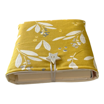 The Book Pouch has elastic and button fastening to ensure books are safely in the Book Pouch.  Please note the book in the photo is not included and is for illustrative purposes only.  