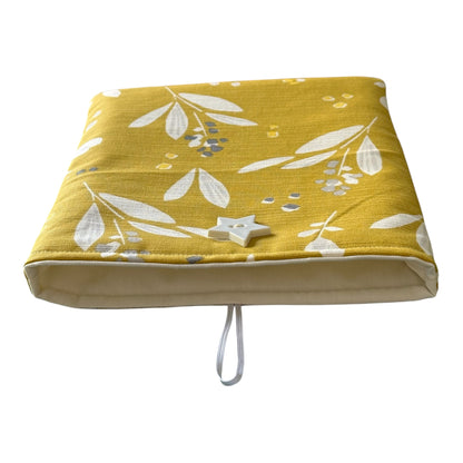 The handmade Book Pouch is lined with neutral cotton fabric and has elastic and white star like shaped button fastening.