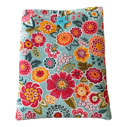 The padded Book Pouch fastens with elastic and a teal coloured button which complements the colours in the fabric.