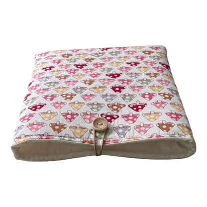 The handmade padded pouch is padded with fusible fleece and wadding, lined with neutral complementing fabric and fastens with button and elastic to keep your device safe from being marked whilst being carried in a bag on the go.  Would also be a great gift Book Lovers Gift idea to protect books from wear and tear.