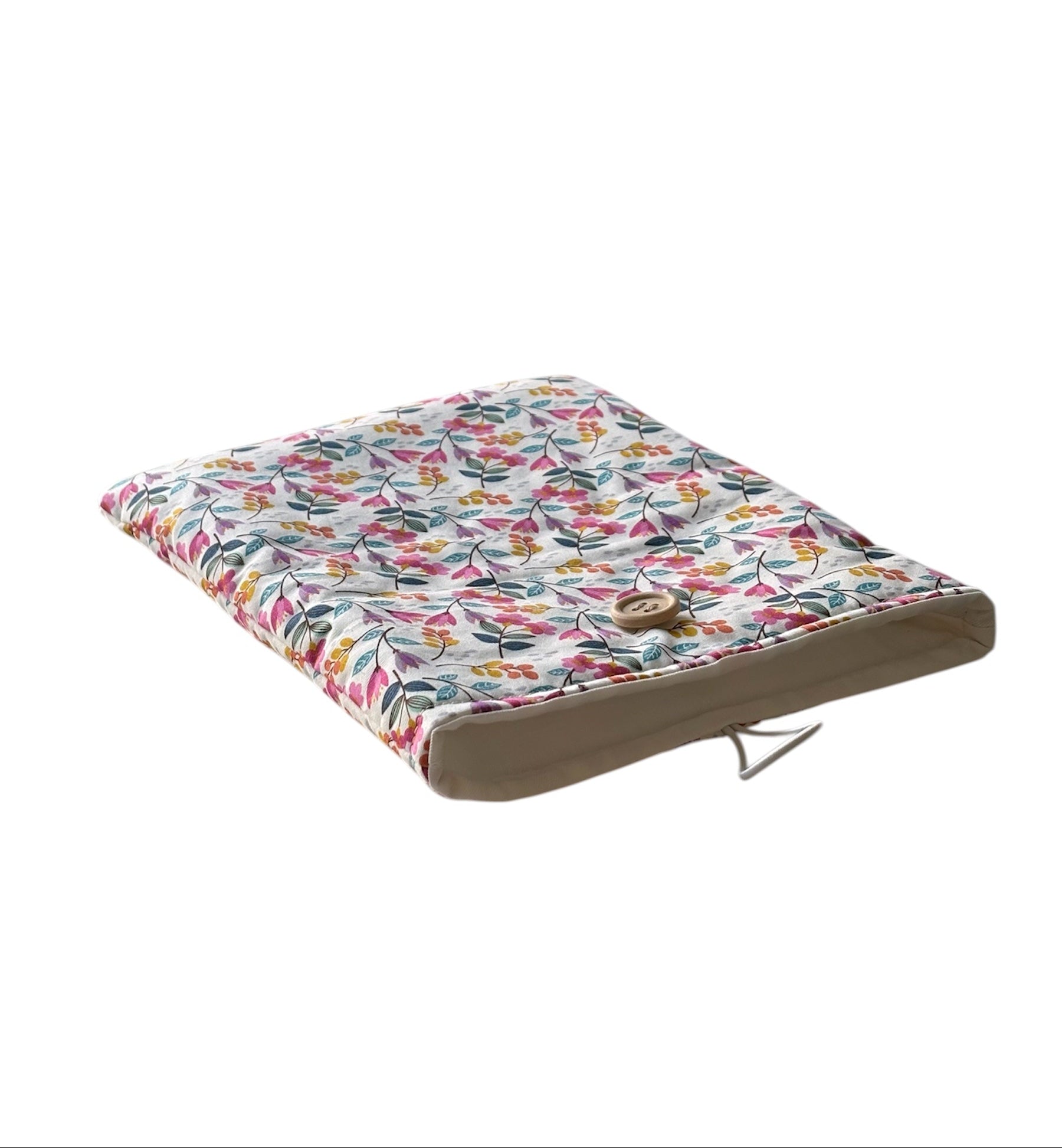 The handmade floral Book Pouch is lined with neutral fabric and fastens with elastic and a button.