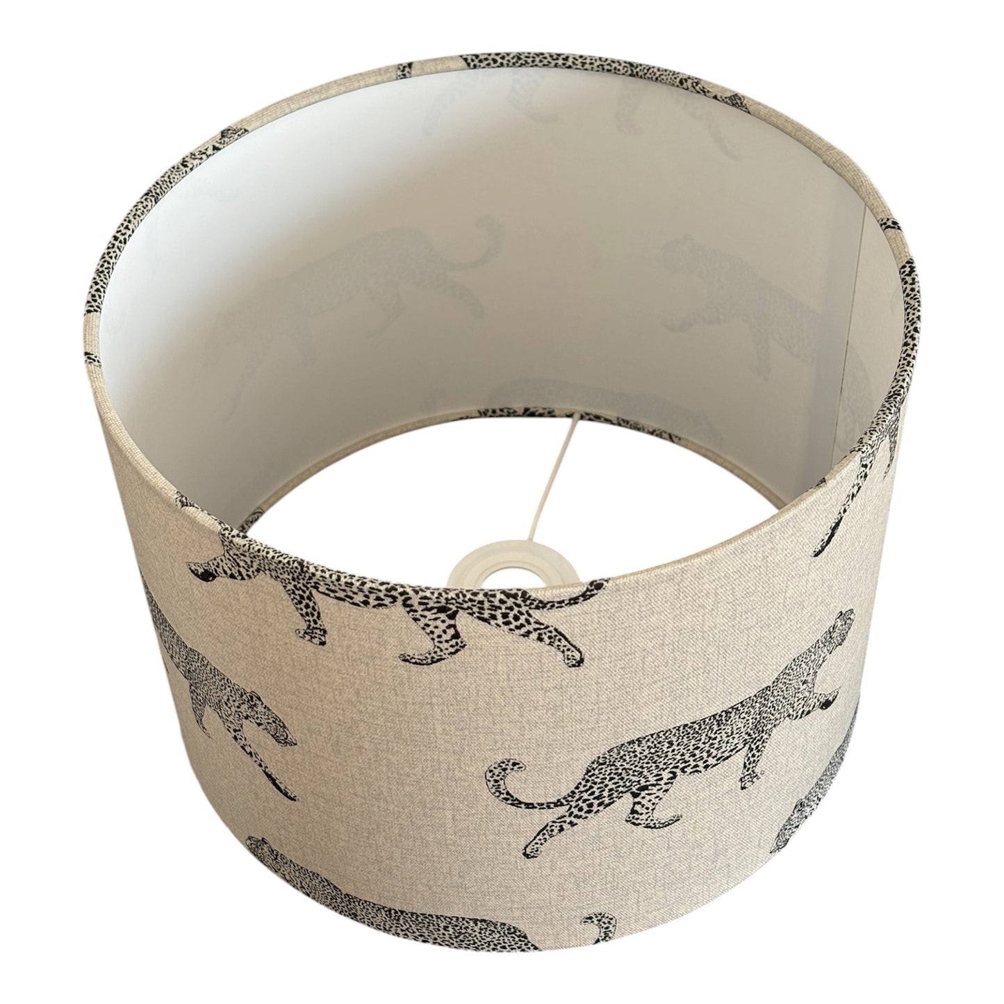 The black leopard print pattern is on a neutral linen look fabric.  The drum lampshade is lined with fire retardant white PVC which meets UK Standards and has passed the Lighting Association Glow Wire Test.