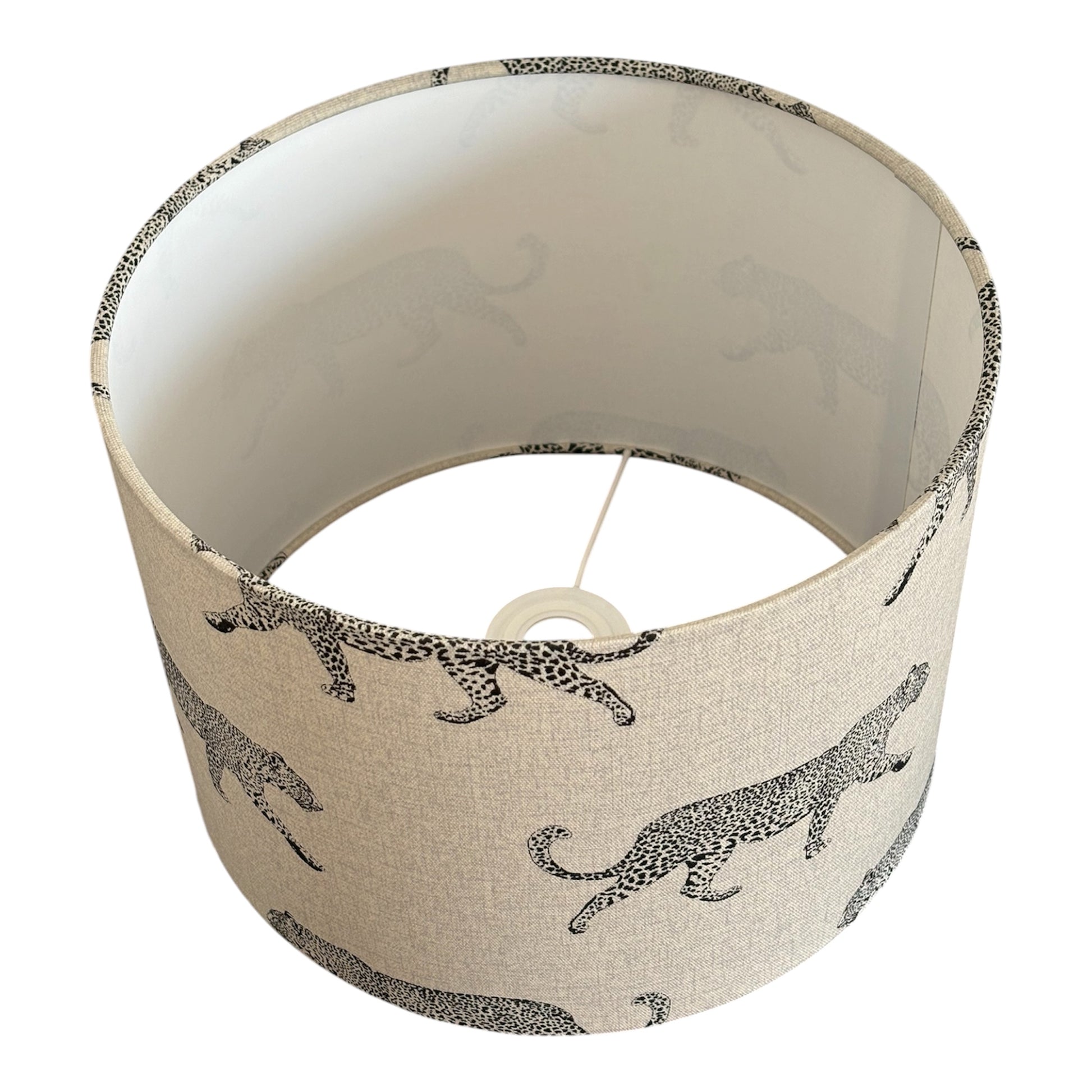 The black leopard print pattern is on a neutral linen look fabric.  The drum lampshade is lined with fire retardant white PVC which meets UK Standards and has passed the Lighting Association Glow Wire Test.