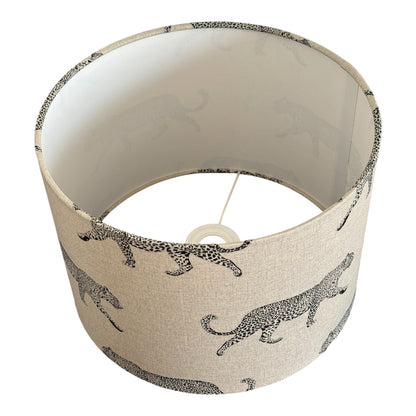 The black leopard print pattern is on a neutral linen look fabric.  The drum lampshade is lined with fire retardant white PVC which meets UK Standards and has passed the Lighting Association Glow Wire Test.