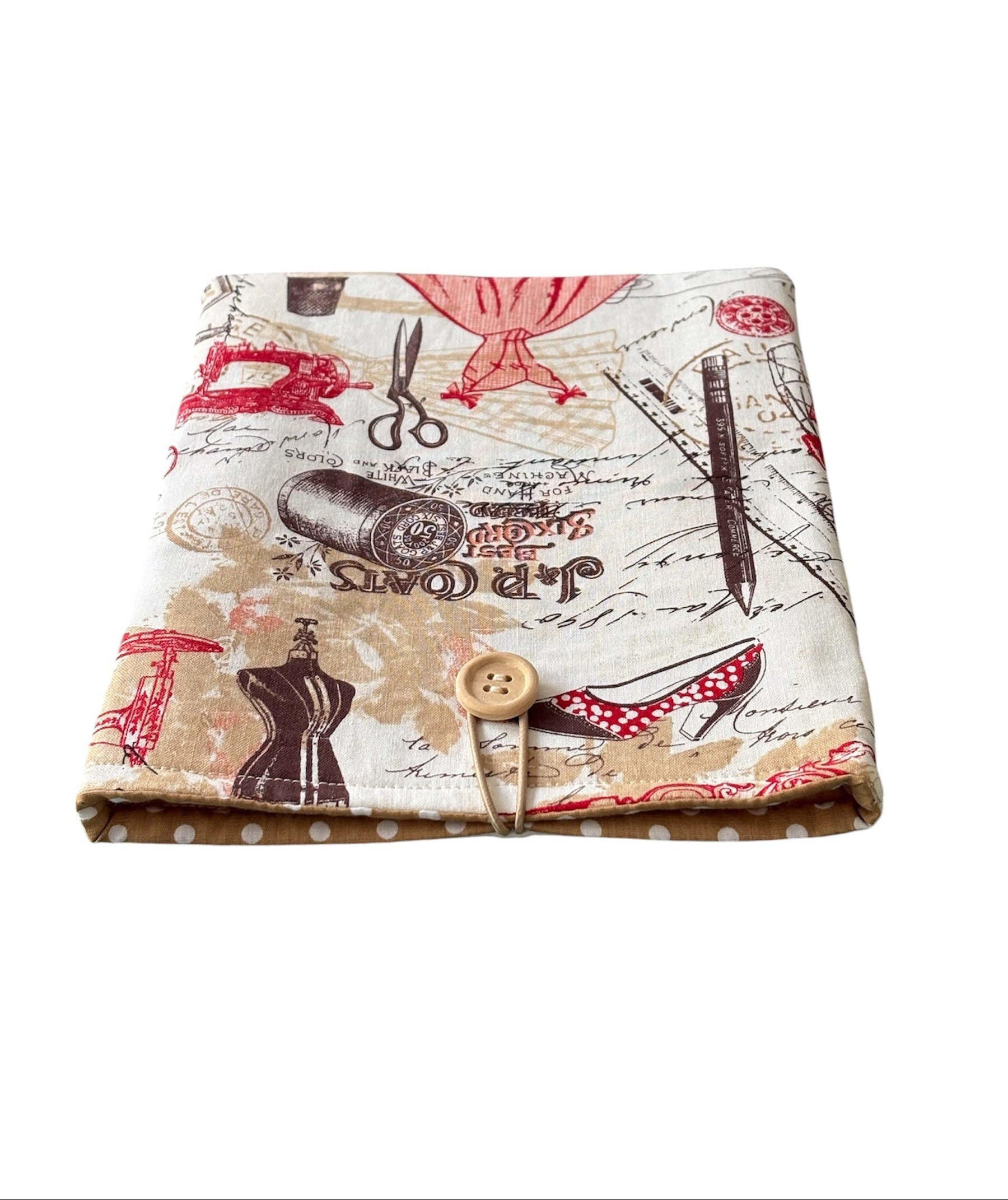 The handmade Book Pouch is padded with fusible fleece, lined with complementing polka dot fabric and has elastic and button fastening.