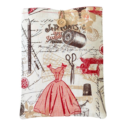 Handmade padded Book Pouch made using red and sepia Vintage Sewing patterned fabric.  The pattern includes a dress, scissors, pencil, sewing machine, thimbles and cotton