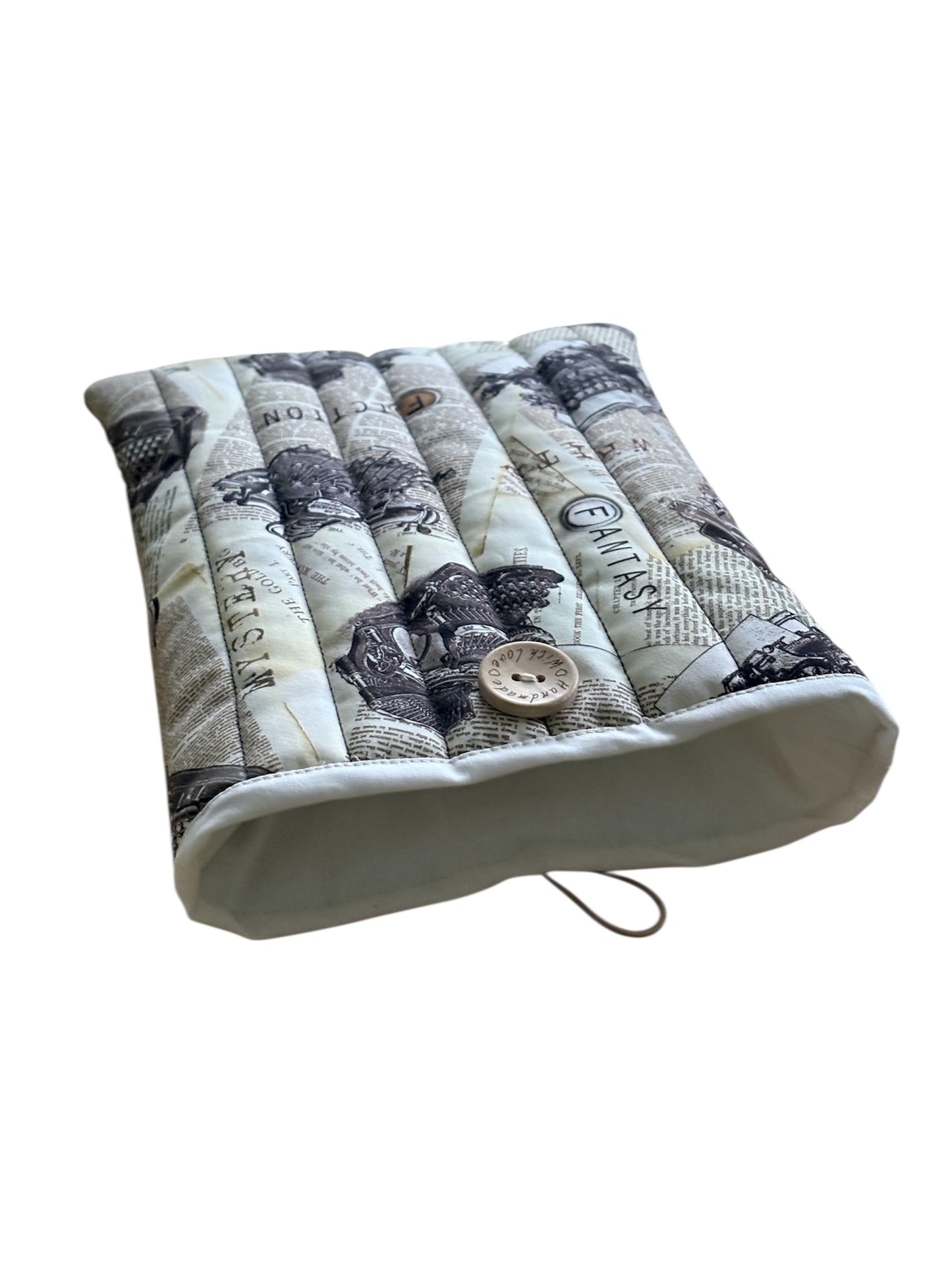 This photo shows more of the neutral fabric which lines the handmade padded Book Pouch.