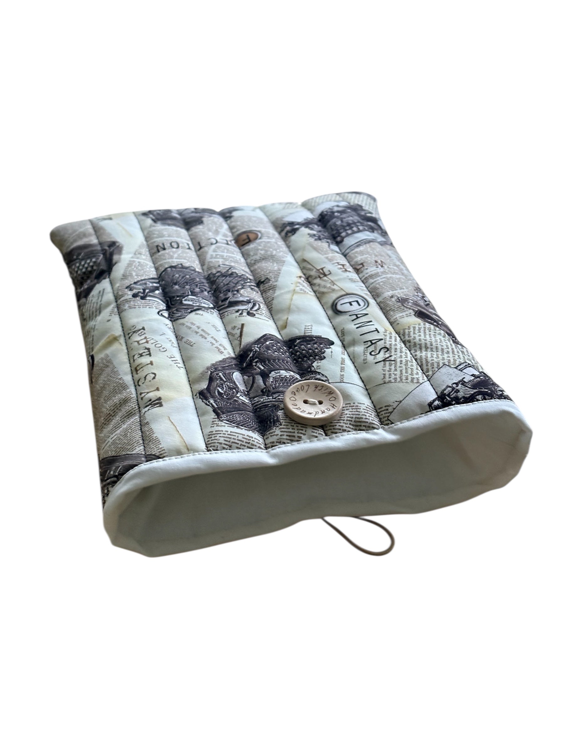 This photo shows more of the neutral fabric which lines the handmade padded Book Pouch.
