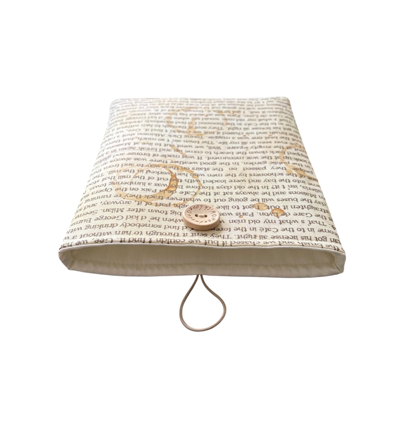 This photo shows the neutral fabric used to line the padded Book Pouch, as well as the elastic and button for fastening