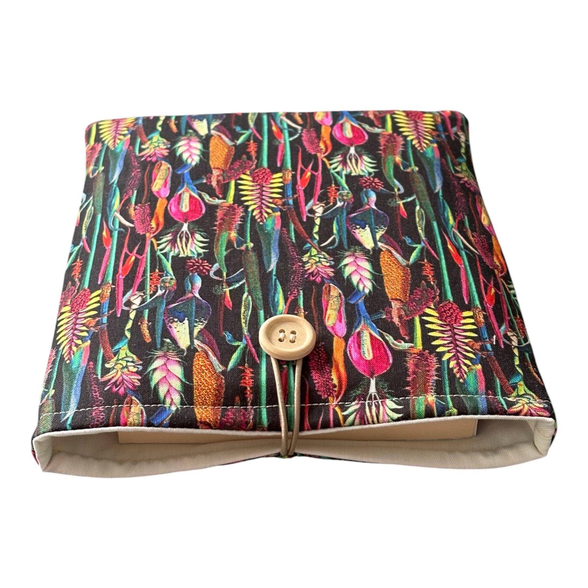 The handmade Book Pouch is padded with fusible fleece, lined with neutral complementing fabric and has elastic and button fastening.  Please note the book in the photo is not included and is for illustrative purposes only.