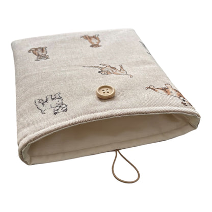 The Book Pouch is padded with fusible wadding, lined with neutral fabric and has elastic and button closure.