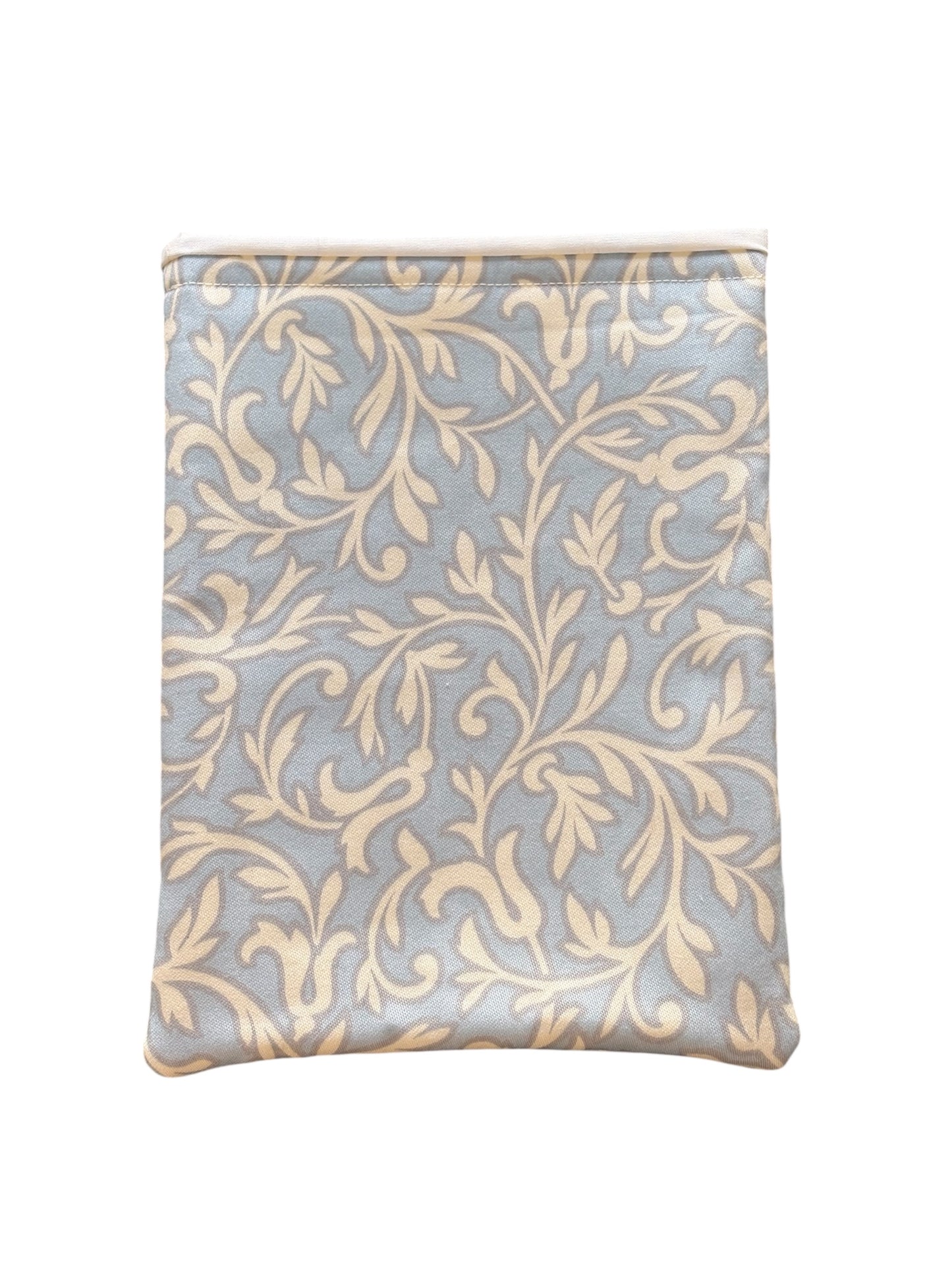 The cream vine leaf style pattern is on a pale blue background, lined with neutral fabric and padded with fusible wadding.  This is an ideal book accessory gift for you or for someone you know who loves reading.