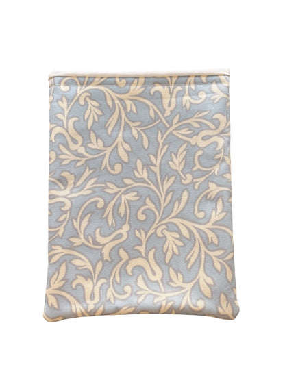 The cream vine leaf style pattern is on a pale blue background, lined with neutral fabric and padded with fusible wadding.  This is an ideal book accessory gift for you or for someone you know who loves reading.