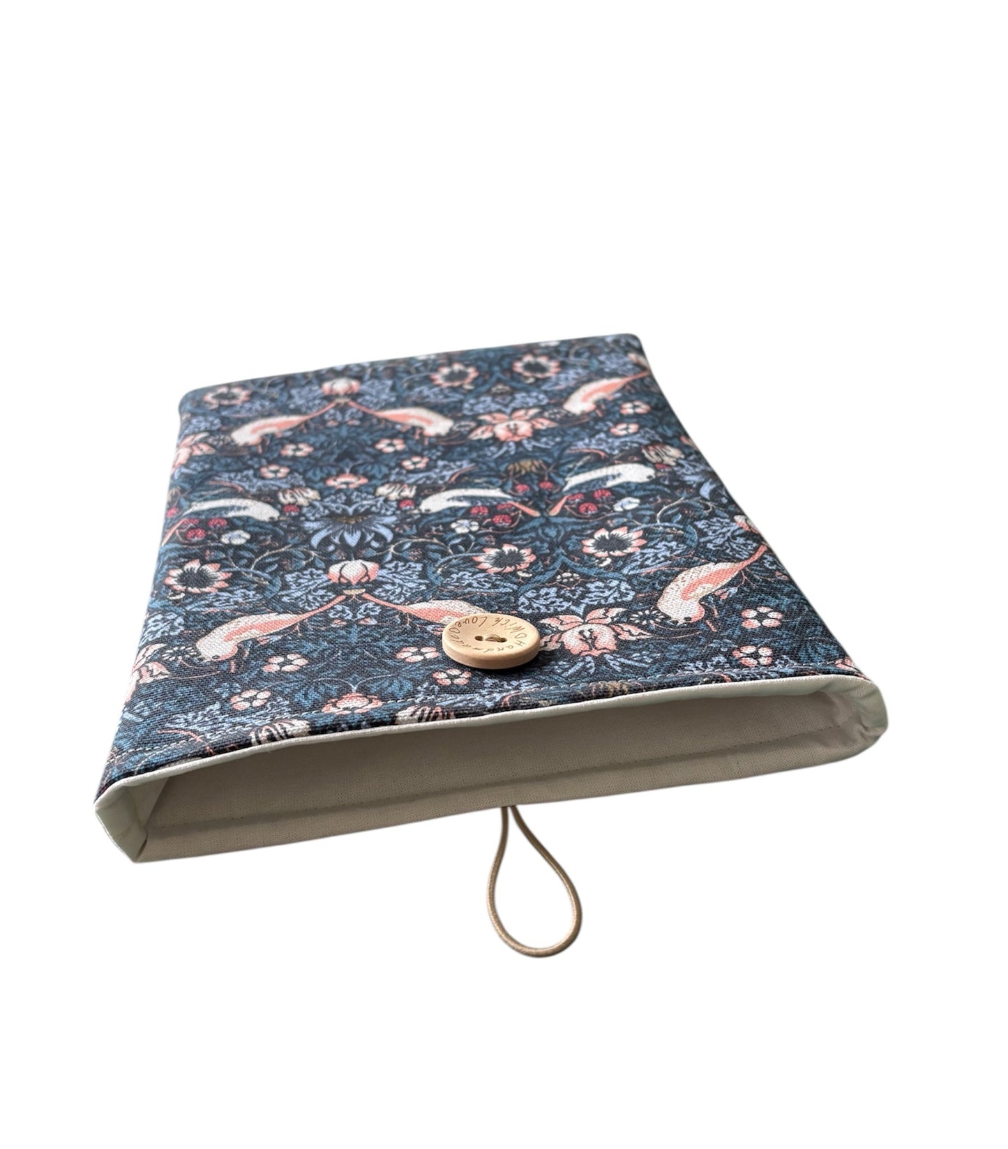 The photo of the Book Pouch shows more of the neutral fabric which lines the handmade Book Cover and elastic and button used which provides closure of the Book Pouch.