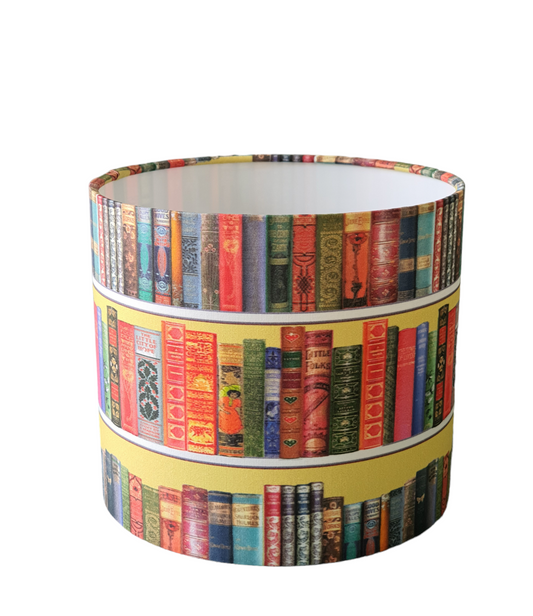 Handmade 25cms drum lampshade made with colourful book patterned fabric.
