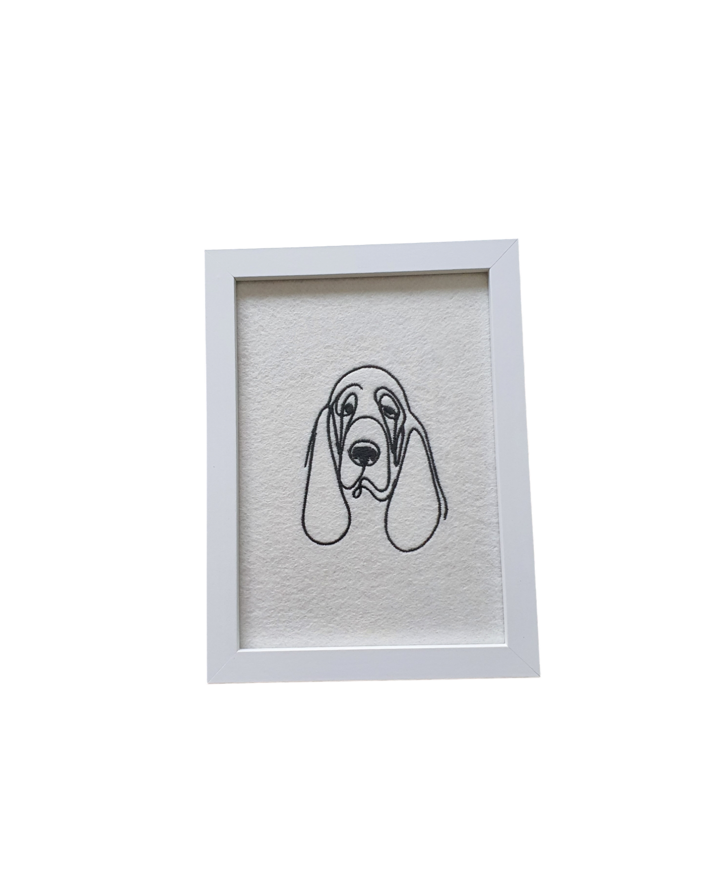 Embroidered Bloodhound dog silhouette in black and presented in a white frame.  A great idea as a Dog Lovers Gift.