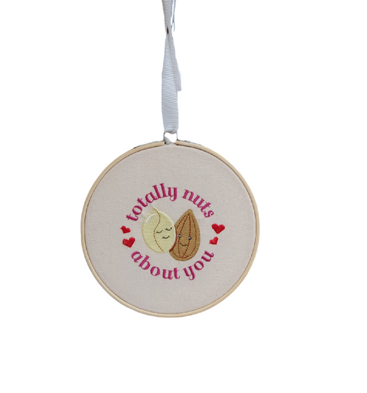 Machine embroidered 6 inch bamboo hoop with loved up beans, hearts and the phrase totally nuts about you.  This would be a lovely gift to show you care.